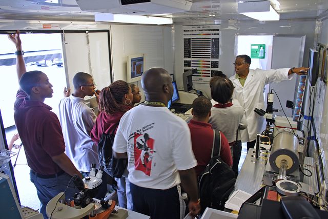 Students and parents attend a demo inside NNIN and Howard University's mobile educational project, the NanoExpress