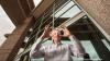 Sandia scientist holds up nanofilm coated glass